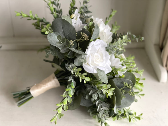 Natural white and green silk wedding flowers with eucalyptus greenery.
