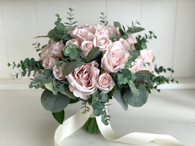 Romantic blush pink wedding flowers with eucalyptus greenery.