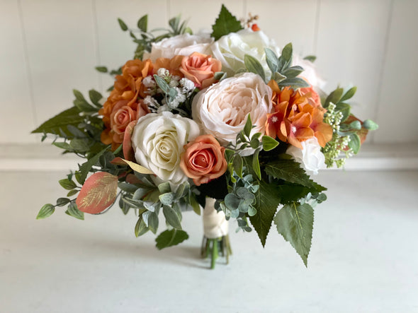 Rustic orange and ivory wedding flowers.