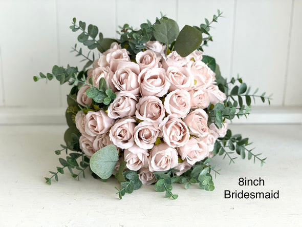 Romantic blush pink wedding flowers with eucalyptus greenery.
