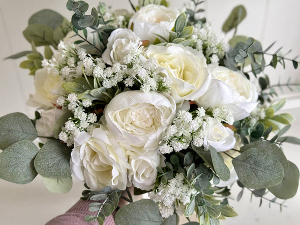 White and sage green artificial wedding flowers. Roses, peonies and gypsophila.