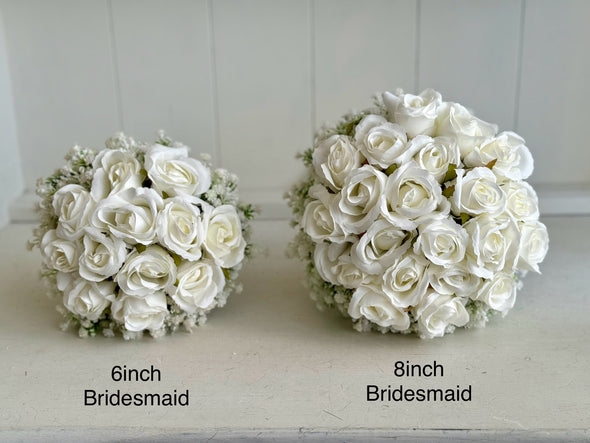 White roses bridesmaid bouquet with baby’s breath.