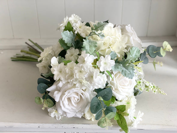 White and green faux flower arrangement