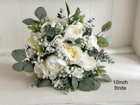 White and sage green artificial wedding flowers. Roses, peonies and gypsophila.