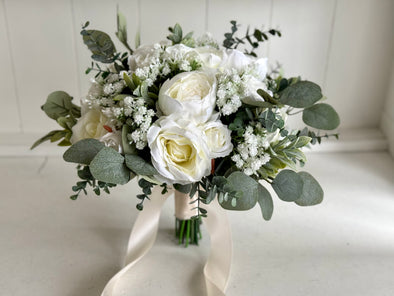 White and sage green artificial wedding flowers. Roses, peonies and gypsophila.