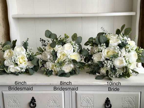 White and sage green artificial wedding flowers. Roses, peonies and gypsophila.