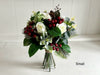 Christmas faux flower tied arrangement. Roses, berries and mixed foliage. *Vase not included