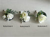 Rustic white and green silk wedding flowers buttonhole options. White roses, gypsophila and eucalyptus. Buttonholes are usually worn by the groom and groomsmen.