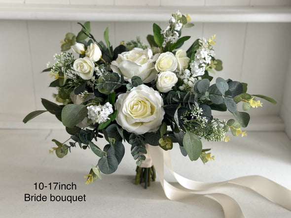 White and green rustic silk wedding flowers bride bouquet. White roses, gypsophila and eucalyptus.