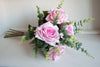 Luxury pink roses and eucalyptus silk flower tied arrangement.