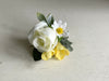 White and yellow wedding buttonhole. Rose, freesia and daisies.