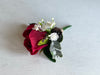 Red rose, gypsophila and pine cone wedding buttonhole