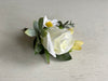 White and yellow wedding buttonhole. Rose, freesia and daisies.