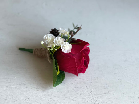 Red rose, gypsophila and pine cone wedding buttonhole